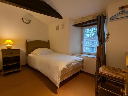 a small bedroom with a bed and a window at Gîte spacieux avec piscine chauffée, jardin, WIFI et animaux admis - FR-1-653-273 in Angeduc