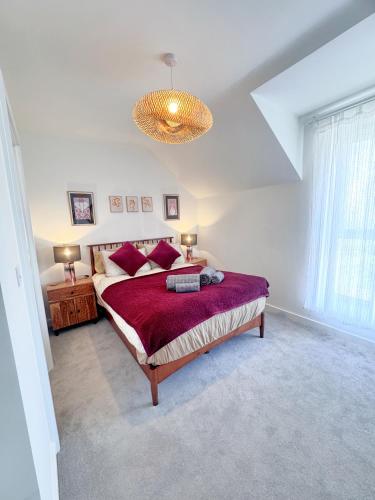 a bedroom with a large bed and a chandelier at Eden Gateway full equipment brand new bright and modern En-suite Double bedroom - room 3 near city centre in Birmingham