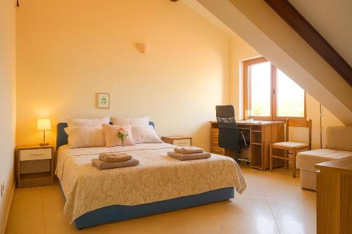a bedroom with a bed with two towels on it at Apartment Bigovo in Tivat