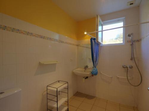 a bathroom with a shower and a sink and a toilet at Gîte campagne proche St-Étienne, animaux admis - FR-1-496-130 in Saint-Héand