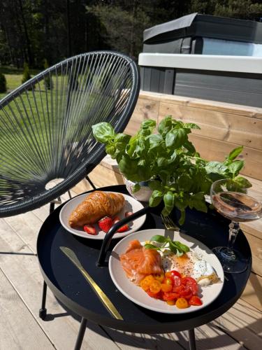 a black table with two plates of food on it at Luxury Tahkuranna villa Pärnu in Laadi