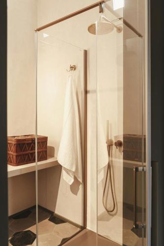 a shower with a glass door in a bathroom at La Canonica Suites in Cannole