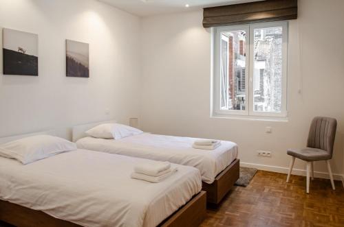 Giường trong phòng chung tại La Veduta - Luxe Apartment with Leie View