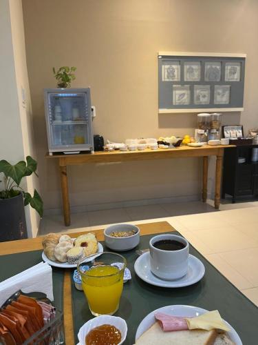 a table with plates of food on top of it at HOTEL LOS TILOS RECONQUISTA in Reconquista