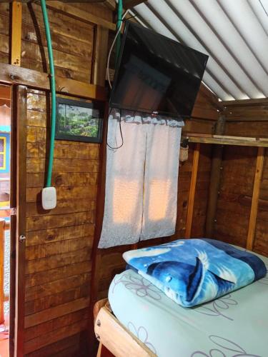 a room with a bed in a wooden cabin at Ecohotel Villa Natalia in Boquía