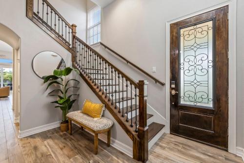 a foyer with a staircase and a wooden door at 114 Mediterranean Way in Indian Harbour Beach