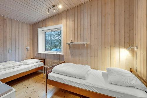 a room with two beds and a window at Holiday Home By Gudenå River With Natural Garden in Bjerringbro