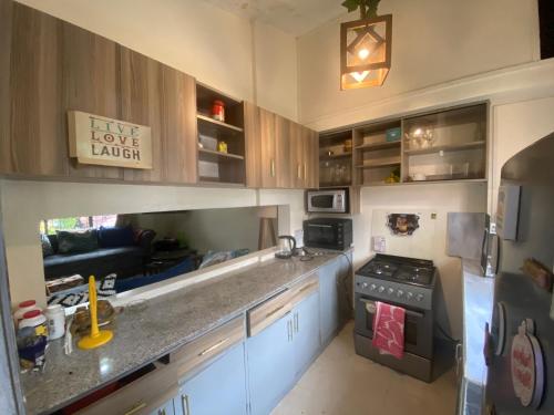 a kitchen with a counter top and a stove at Perfect gate away for Leisuere ,Holiday and Business in Nairobi