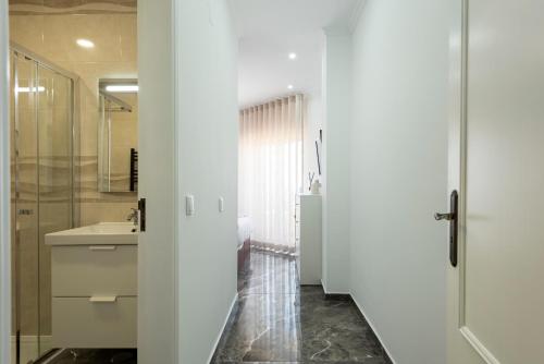 a bathroom with a shower and a sink at Espadarte - Sea view by HD in Quarteira