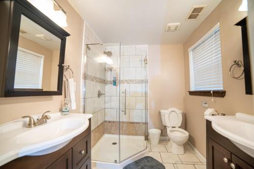 a bathroom with a shower and a sink and a toilet at Lush Hideaway with HotTub & Pool 6 mins kings Island in Mason