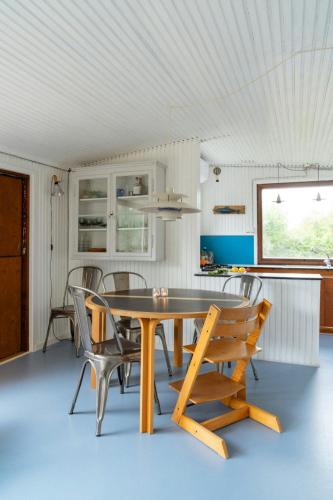 a dining room with a wooden table and chairs at Adorable Retro Home With Lovely Terrace in Bryrup