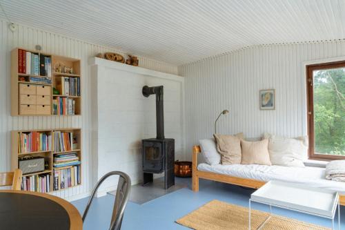 a living room with a couch and a wood stove at Adorable Retro Home With Lovely Terrace in Bryrup
