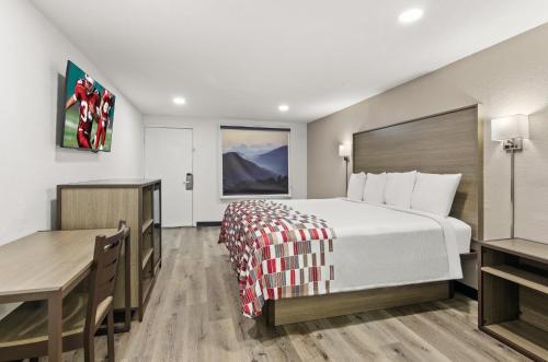 a hotel room with a bed and a desk at Red Roof Inn Wytheville in Wytheville