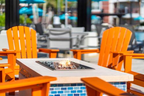 a table with chairs and a fire pit on it at Vista Cay Resort by Millenium at Universal Blvd. in Orlando