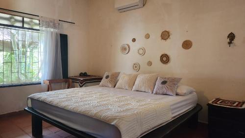a bedroom with a large bed in a room at Finca Hotel Auraviva in Ciénaga de Oro