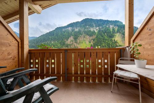 a screened in porch with a table and chairs at Hotel Brunello in Ortisei