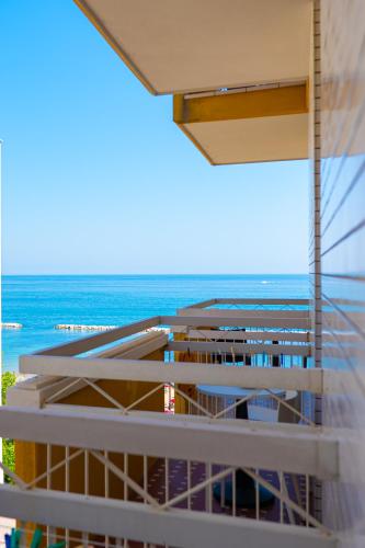a view of the ocean from the balcony of a building at Hotel Palazzi in Gabicce Mare