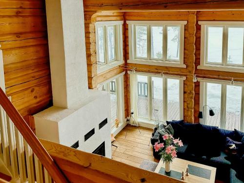 a living room with a staircase in a wooden house at Hand-Built Log Cabin By The Lake In Vemdalen in Klövsjö