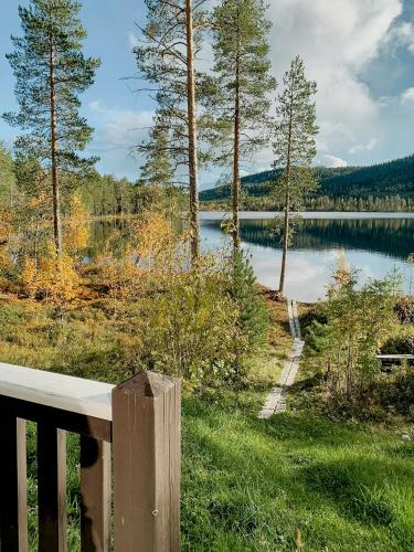 a view of a lake from a wooden bench at Hand-Built Log Cabin By The Lake In Vemdalen in Klövsjö