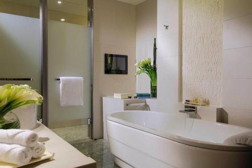 a white bathroom with a tub and a sink at InterContinental Suzhou Hotel by IHG in Suzhou