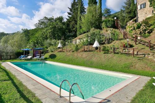 a swimming pool in a yard with a house at Villa With Views Over Lucca Hills in Matraia