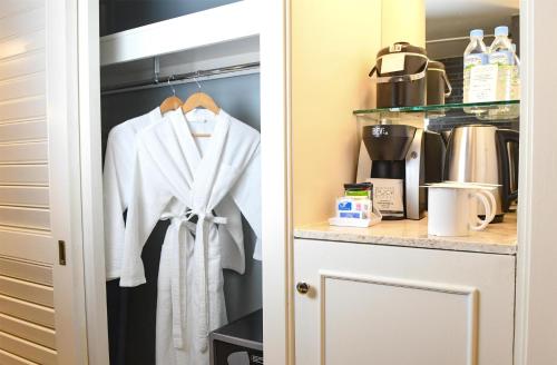 a white robe hanging in a kitchen pantry at Hilton Guam Resort & Spa in Tumon