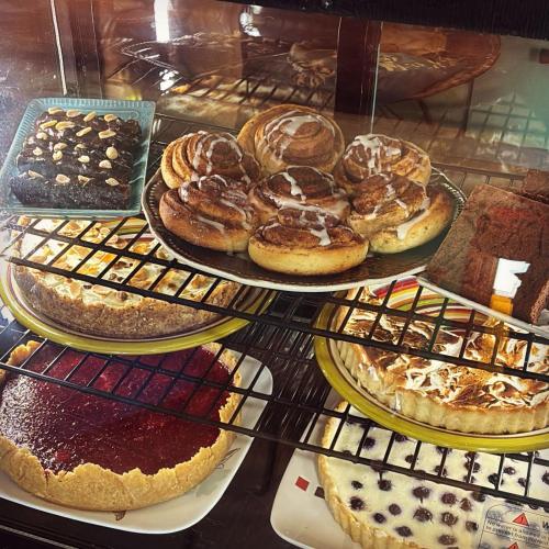 a display case with a bunch of different types of pastries at Los Rukos Cabanas (Bungalows) in Pichilemu