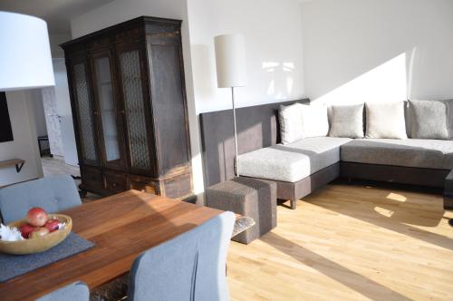 a living room with a couch and a table at Alpenchalet Apartments in Parcines