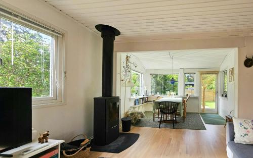 a living room with a wood stove in a room at Holiday Home With Two Annexes Near The Sejerø Bay in Høve