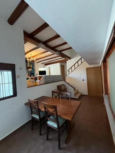 a dining room with a wooden table and chairs at Charming Villa in Punta Umbría with Private Pool in Punta Umbría