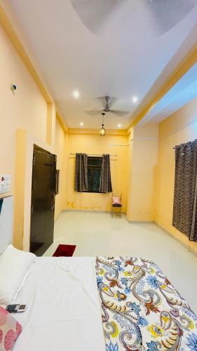 a bedroom with a large bed in a room at KIARSH RESIDENCY HOME Stay in Varanasi