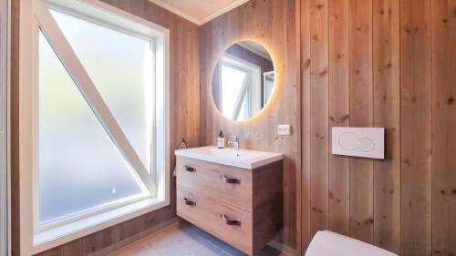 a bathroom with a sink and a mirror at Modern Family Cabin At Hovden Alpin in Hovden