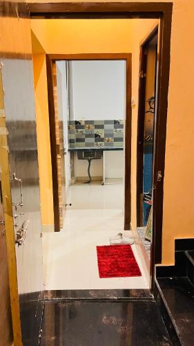 a view of a room with a red rug at KIARSH RESIDENCY HOME Stay in Varanasi
