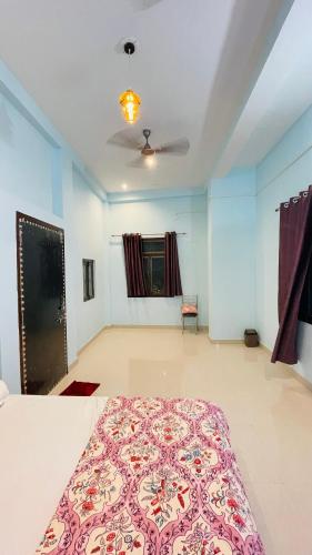 a bedroom with a large bed in a room at KIARSH RESIDENCY HOME Stay in Varanasi