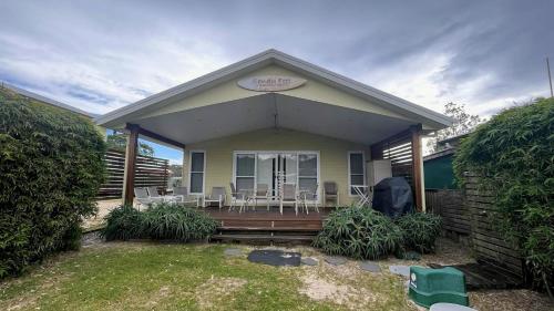 a house with a porch with chairs on it at Sandy Feet in Wooli