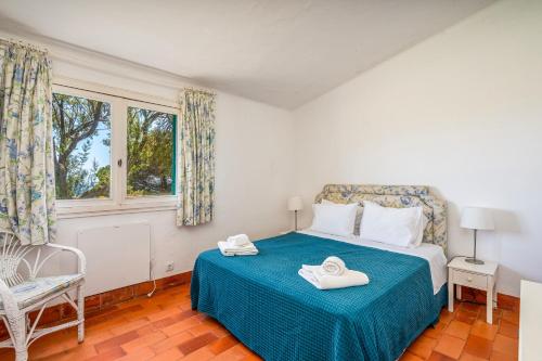 a bedroom with a bed with two towels on it at Ocean Villa Algarve in Alvor