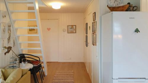 a small room with a staircase and a refrigerator at Cabin In The Archipelago On The Island Kinn in Tansøy