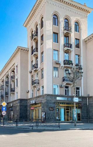 a large building on a street in front of a building at 21 На удачу in Rustavi