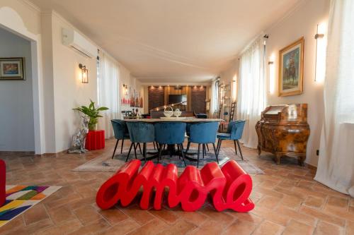 a living room with a table and blue chairs at Apartment In A Villa In The Green Heart Of Umbria in Stroncone