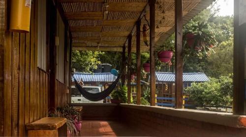a porch with a hammock in the window of a building at Ecohotel Villa Natalia in Boquía
