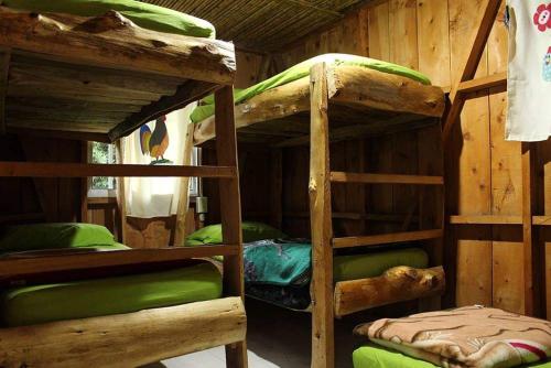 a room with two bunk beds in a cabin at Ecohotel Villa Natalia in Boquía