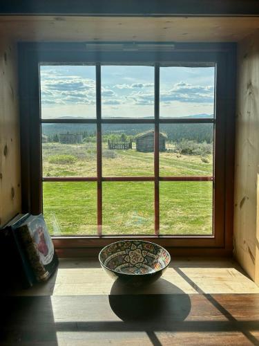 a large window with a bowl in front of it at Historic Log Cabin With Views Of Rondane in Ringebu