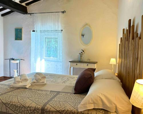 a bedroom with a large bed with towels on it at Historic Farmhouse In Maremma Countryside in Poggio Murella