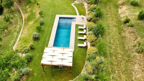 an overhead view of a swimming pool in a yard at Historic Farmhouse In Maremma Countryside in Poggio Murella