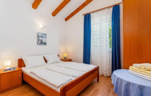 een slaapkamer met een bed en een raam met blauwe gordijnen bij Vila Medea sea view by Villas Guide in Medveja