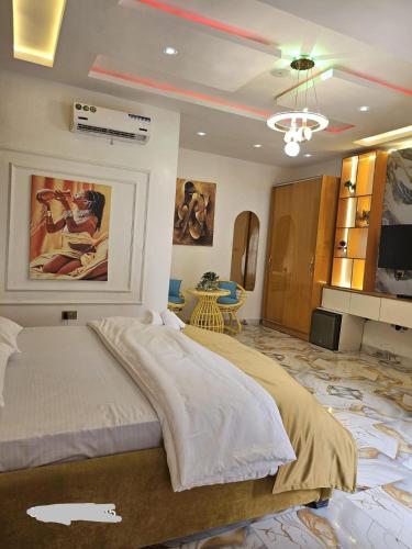 a bedroom with a large bed and a table at luxury 3bed rooms duplex lekki Lagos nigeria in Lekki
