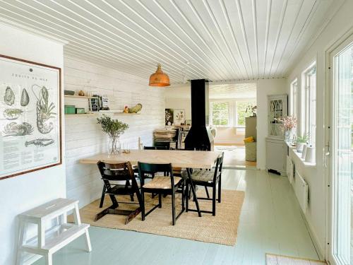 a kitchen with a dining room table and chairs at Cozy Spacious Cottage By Water And Nature in Brastad