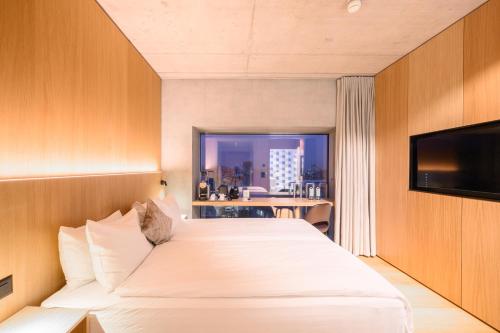 a hotel room with two beds and a window at Placid Hotel Design & Lifestyle Zurich in Zürich