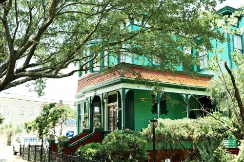 a green house in front of a building at Victorian Modern Room in Carriage House - Unit B in Savannah