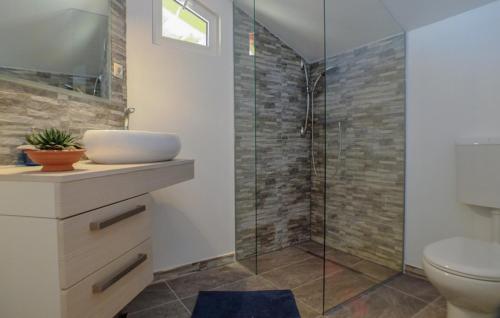 a bathroom with a sink and a glass shower at Villa Ema - Makarska by Villas Guide in Donji Vinjani